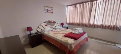 a small bedroom with a bed and a window at Dpt suite pardo 610 in Lima