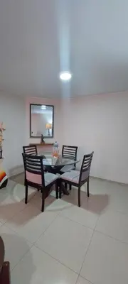 a dining room with a table and four chairs at Dpt suite pardo 610 in Lima