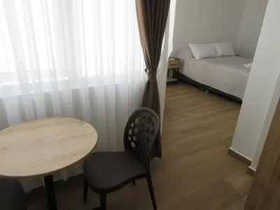 a small room with a table and a bed at Venue Studios in Lima