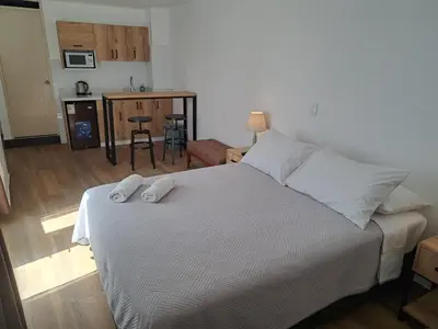a bedroom with a bed with two towels on it at Venue Studios in Lima