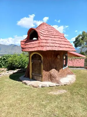 a small gingerbread house with a red roof at Casa al lado del Bosque in Oxapampa