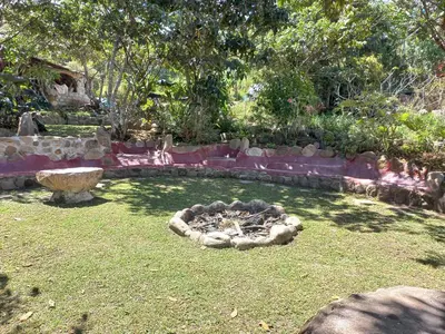 a garden with a fire pit in the grass at Casa al lado del Bosque in Oxapampa