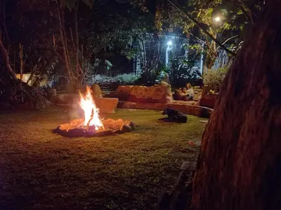 a fire pit in the yard at night at Biosfera Lodge tipi para 3 personas in Oxapampa