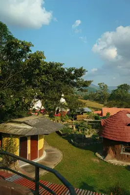 a view of a small house with a yard at BIOSFERA LODGE GLAMPING tipi 2 personas in Oxapampa