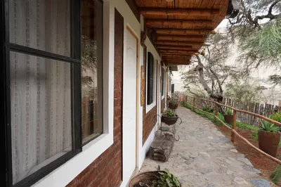 a porch of a house with a bench and windows at Rochabus in Ica