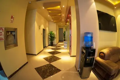 a hotel room hallway with a drink dispenser in a building at R&N SHULLKAS SUITES in Huancayo