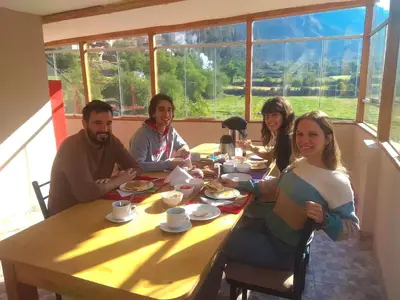 a group of people sitting at a table eating food at Ayllu B&B Ollantaytambo in Ollantaytambo