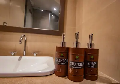 two bottles of soap sitting on a bathroom sink at Saska Boutique Hotel in Cusco
