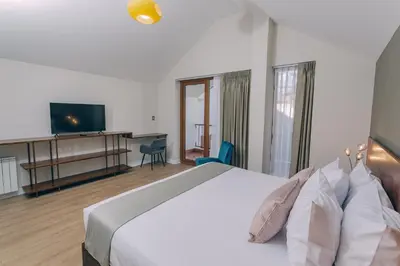 a hotel room with a bed and a television at Saska Boutique Hotel in Cusco