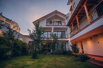 an exterior view of a building with a yard at Saska Boutique Hotel in Cusco