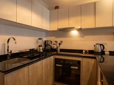 a kitchen with a sink and a stove top oven at Espacio Luxury Apartments - Edificio Pedro de Osma in Lima