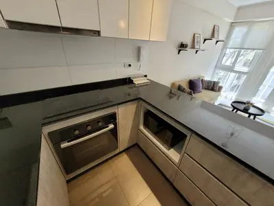 a kitchen with a sink and a stove at Espacio Luxury Apartments - Edificio Pedro de Osma in Lima