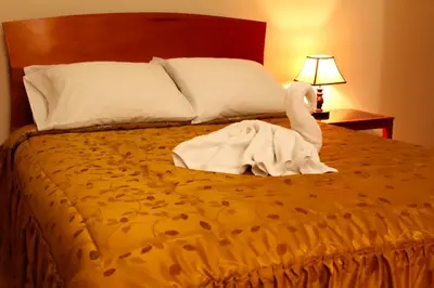a swan made out of towels is sitting on a bed at Hotel Conquistador in Andahuaylas