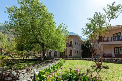a house with a garden in front of it at Inti Punku Valle Sagrado Hotel in Urubamba