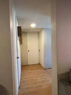 an empty room with a hallway leading to a door at Hermoso departamento totalmente amoblado - Lte San Miguel in Lima