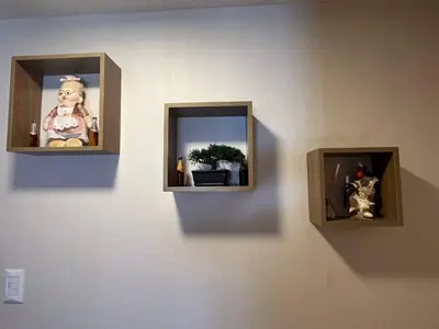 two pictures on a wall with a stuffed animal in it at Hermoso departamento totalmente amoblado - Lte San Miguel in Lima