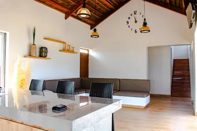 a living room with a couch and a table at HOP PRAIA exclusiva laguna y playa en Chincha in Chincha Baja