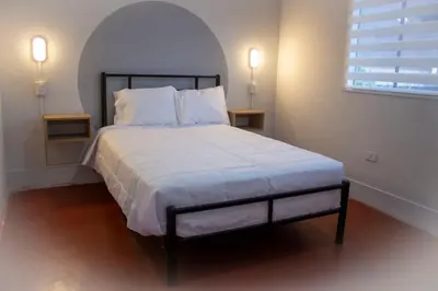 a bedroom with a large bed with two night stands at Casa Kutimuy in Ayacucho