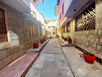 an alley with potted plants on the sides of buildings at Cusco Centro Home in Cusco