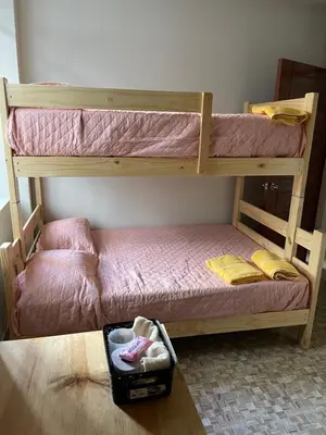 two bunk beds sitting in a room with a box at Casa completa piscina 3 Habitaciones en Chanchamayo in La Merced
