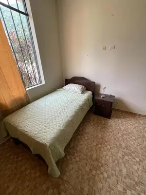 a small bedroom with a bed and a window at Casa completa piscina 3 Habitaciones en Chanchamayo in La Merced