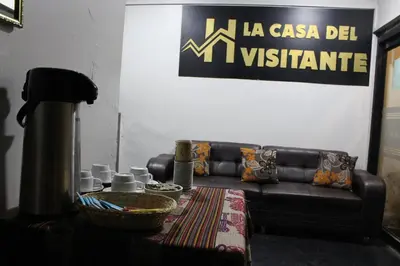 a living room with a leather couch and a table at LA CASA DEL VISITANTE in Cusco