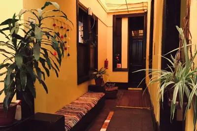 a hallway with potted plants and a couch in a room at KORICANCHA in Lima