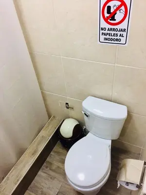 a bathroom with a toilet and a sign that says no anal parties at indoor at KORICANCHA in Lima