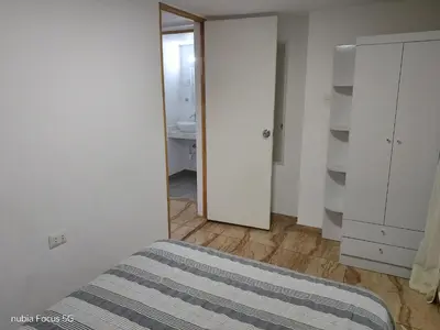 a bedroom with a bed and a closet and a mirror at Acogedor departamento en el centro de Barranco in Lima