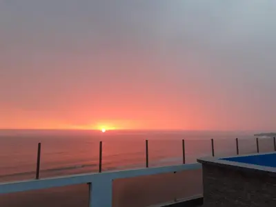 a sunset from the balcony of a condo at Hotel Terrazas Del Mar in Huacho