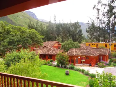 a view from the balcony of a house with a yard at Tierra Viva Ollantaytambo in Ollantaytambo