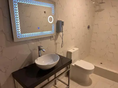 a bathroom with a sink and a toilet and a mirror at Casona Plaza Hotel Cusco in Cusco