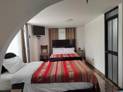 a bedroom with a large bed in a room at Hostal Killaly Inn Cusco in Cusco