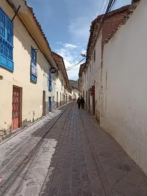 an alley with people walking down a street at Hostal Killaly Inn Cusco in Cusco