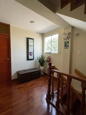 a living room with a couch and a window at HOSPEDAJE LAS FLORES ICA in Ica