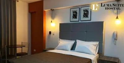 a bedroom with a bed and a table at LUMA SUITE in Lima