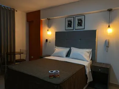 a bedroom with a large bed with two cups on it at LUMA SUITE in Lima