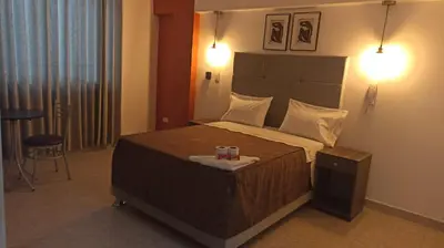 a bedroom with a bed with a candle on it at LUMA SUITE in Lima