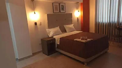 a bedroom with a large bed in a room at LUMA SUITE in Lima