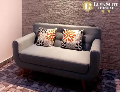a gray couch with pillows on it in a room at LUMA SUITE in Lima