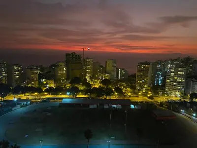 a city skyline at night with a parking lot at Chic & Ocean View Apartment in Lima
