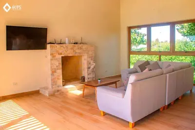 a living room with a couch and a fireplace at HOP LAGO & MAR exclusiva en playa de chincha in Chincha Baja