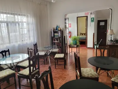 a room with tables and chairs and a room with a mirror at Natural B&B Guest House in Cusco