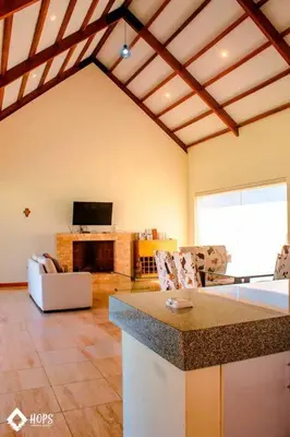 a living room with a fireplace and a tv at HOP OHANA exclusiva en campo y playa en Chincha in Chincha Baja