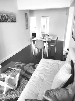 a living room with a bed and a dining table at Espacio Luxury Apartments Malecón 2 in Lima