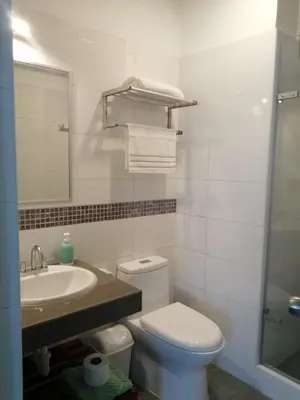 a bathroom with a toilet and a sink and a mirror at NEREO rooms in Lima