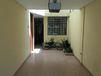 a hallway with a bike parked in a building at Acojedor in Lima