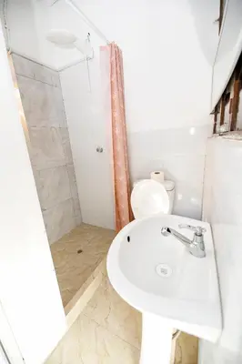 a bathroom with a sink and a toilet at PARDOS HOUSE INN in Cusco