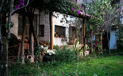a house with flowers in front of it at Eco Lodge Los Perales-Urubamba in Urubamba