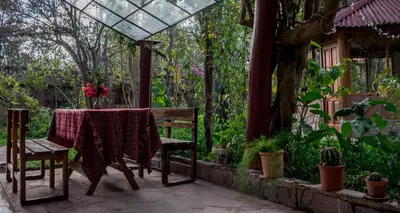 a table and two chairs on a patio at Eco Lodge Los Perales-Urubamba in Urubamba